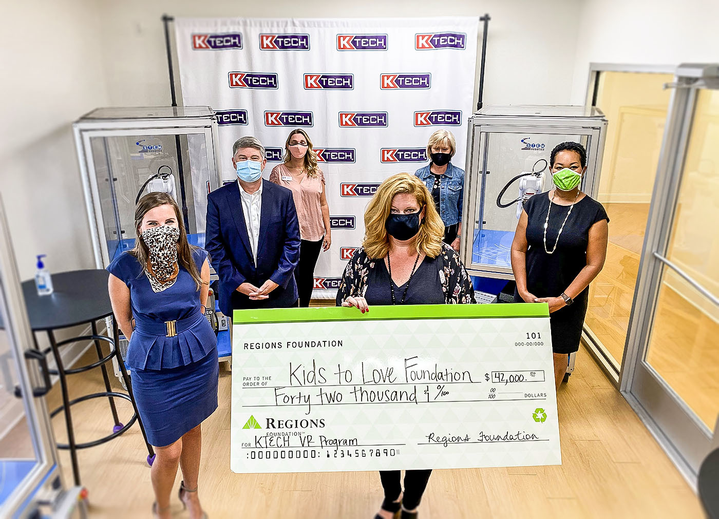 bankers standing with large check