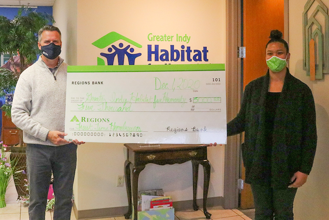 Nicole Woodson and Jim Morris presenting a check to Habitat for Humanity