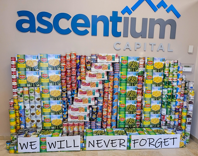 photo of Ascentium can sculpture. Sculture is of the numbers "9 / 11" with text underneath that reads, "We will never forget."