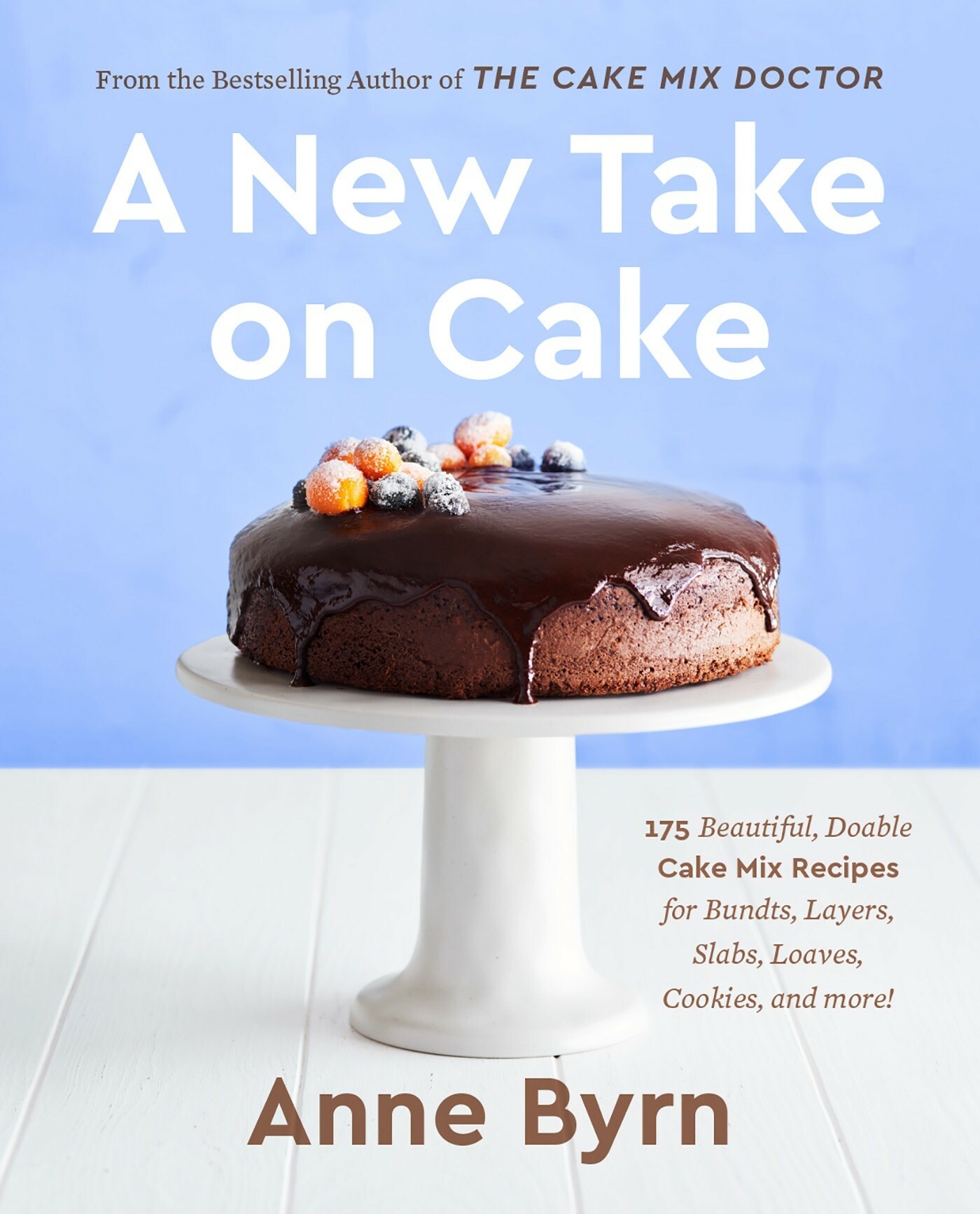 cover of, A New Take on Cake, from The Cake Mix Doctor, by Anne Byrn. Chocolate cake on a cake stand against a blue wall. 