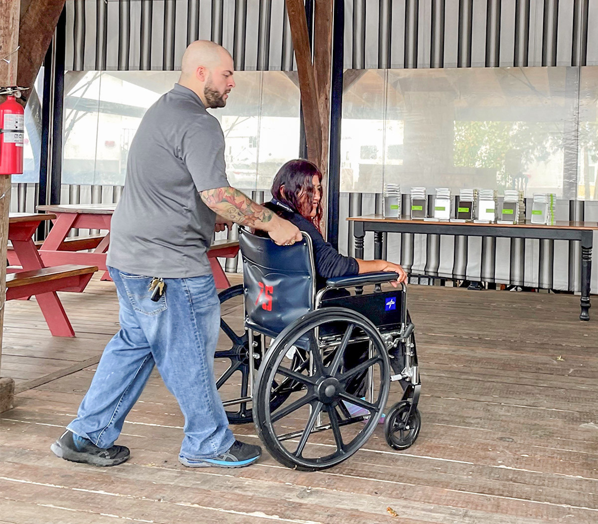 photo of a man pushing a woman in a wheelchair.