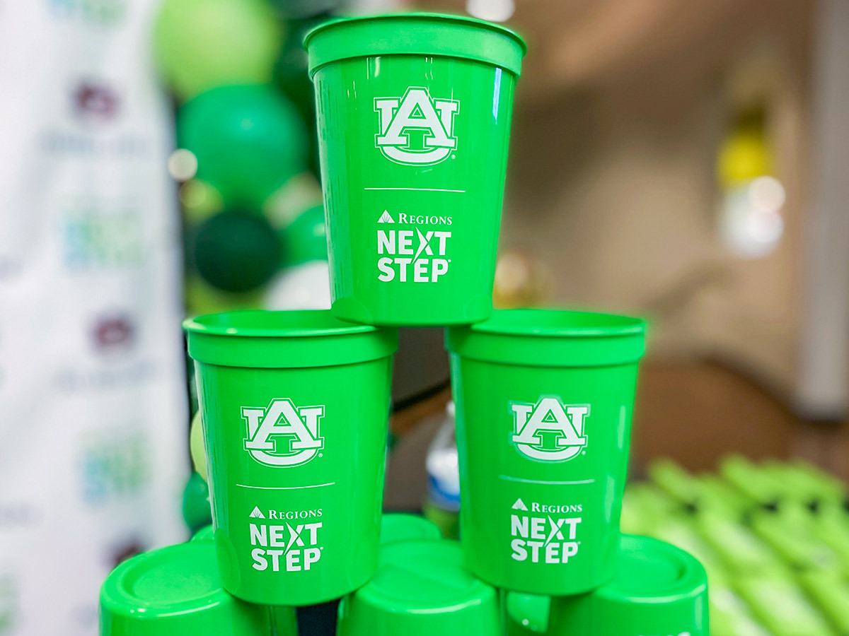 Next Step and Auburn University branded cups arranged in a pyramid