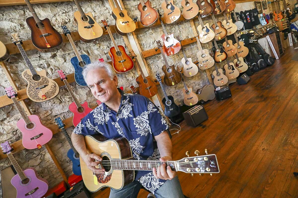 Ken Covington strums a tune at Ken’z Guitars & Music Store.