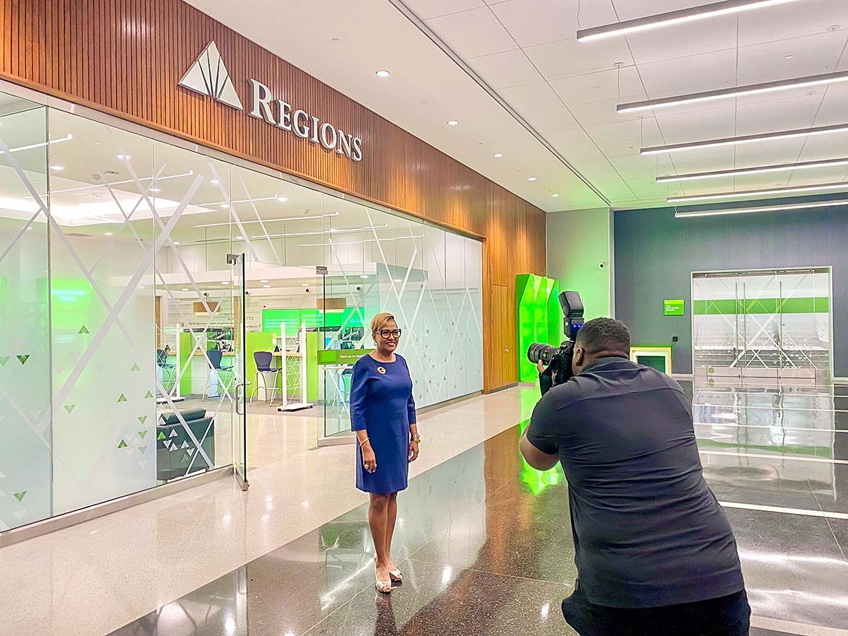 Clara Green being photographed in front of a Regions Bank branch