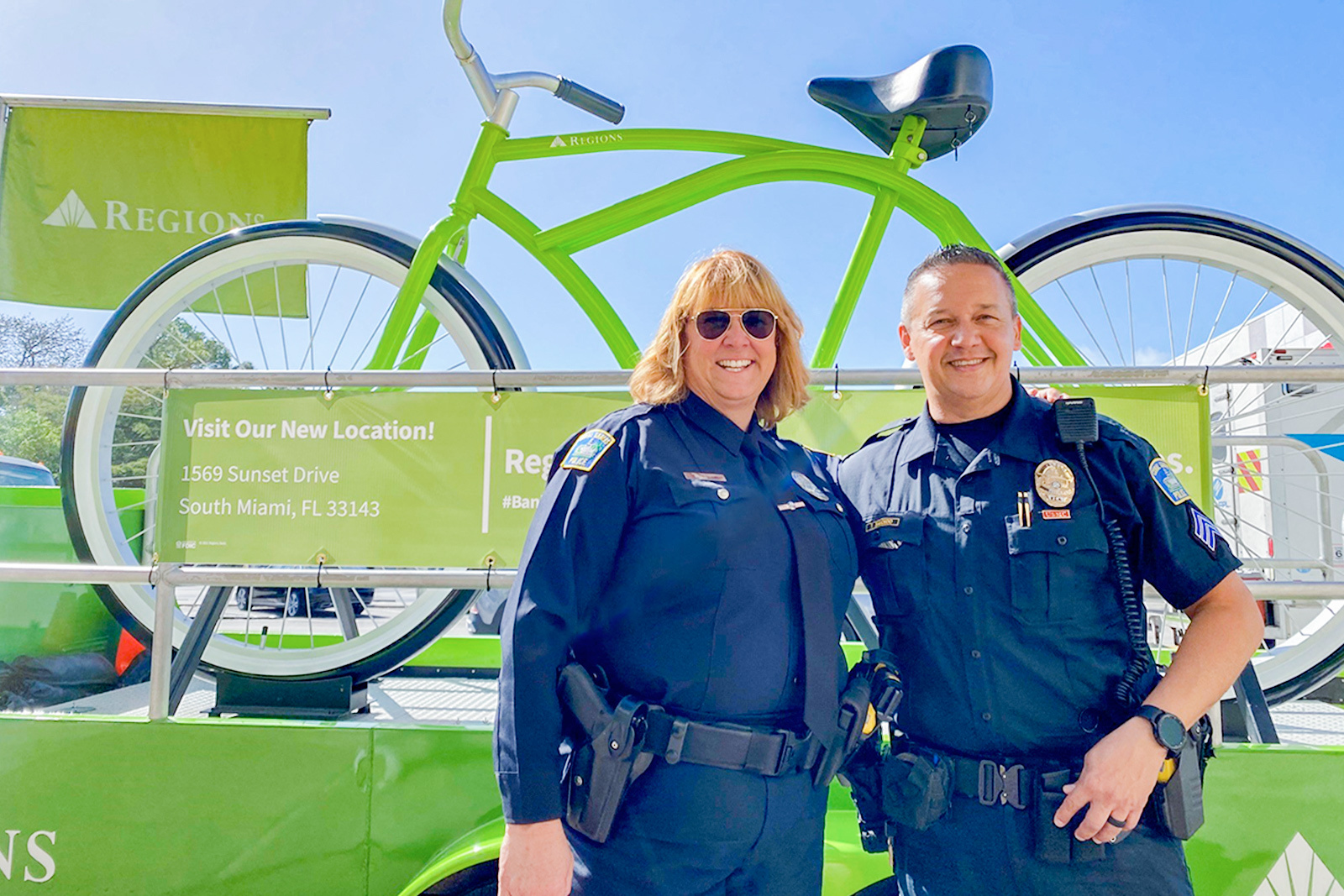 Two police officers in front of Reions Big Bike at appreciation event