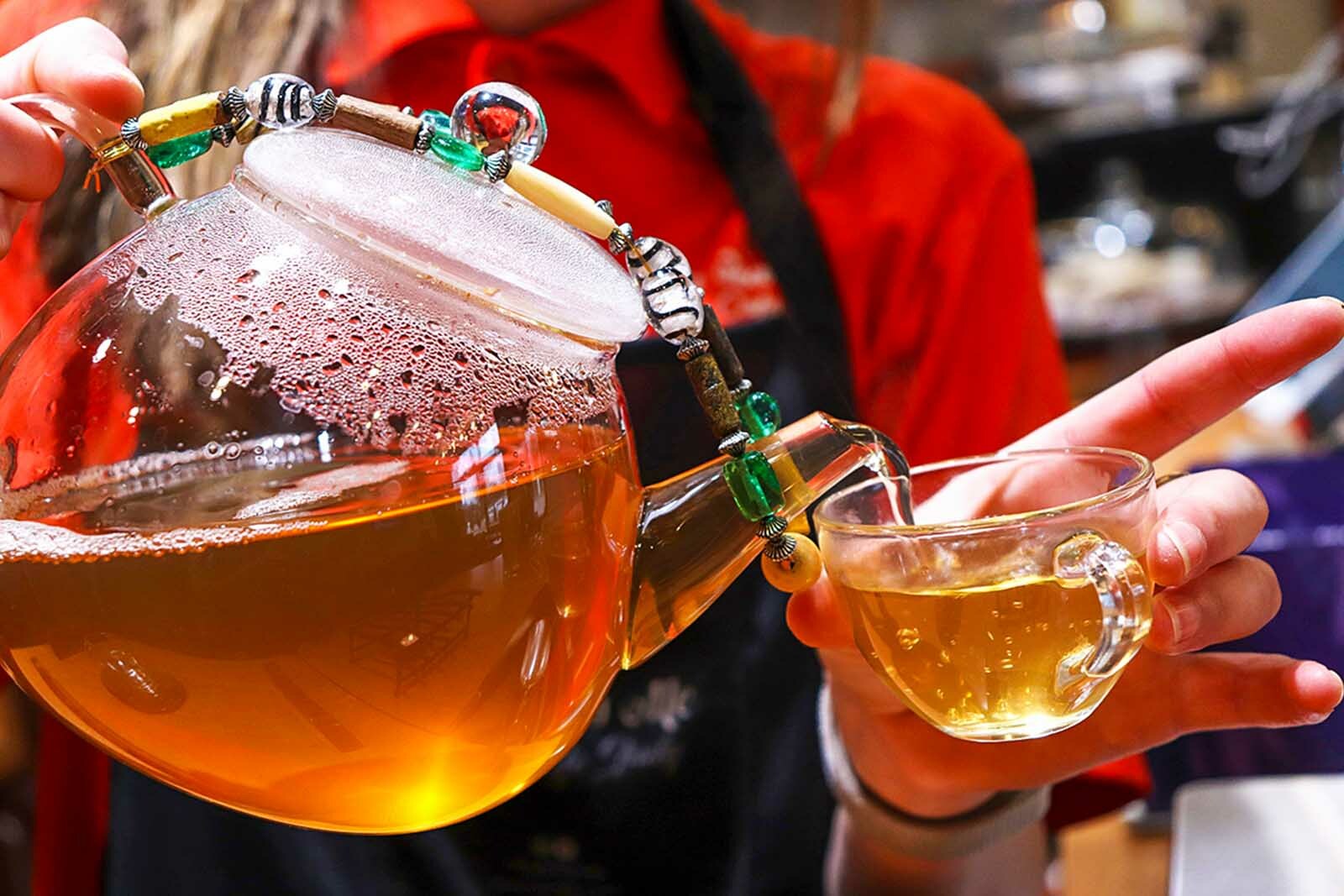 closeup photo of someone pouring tea