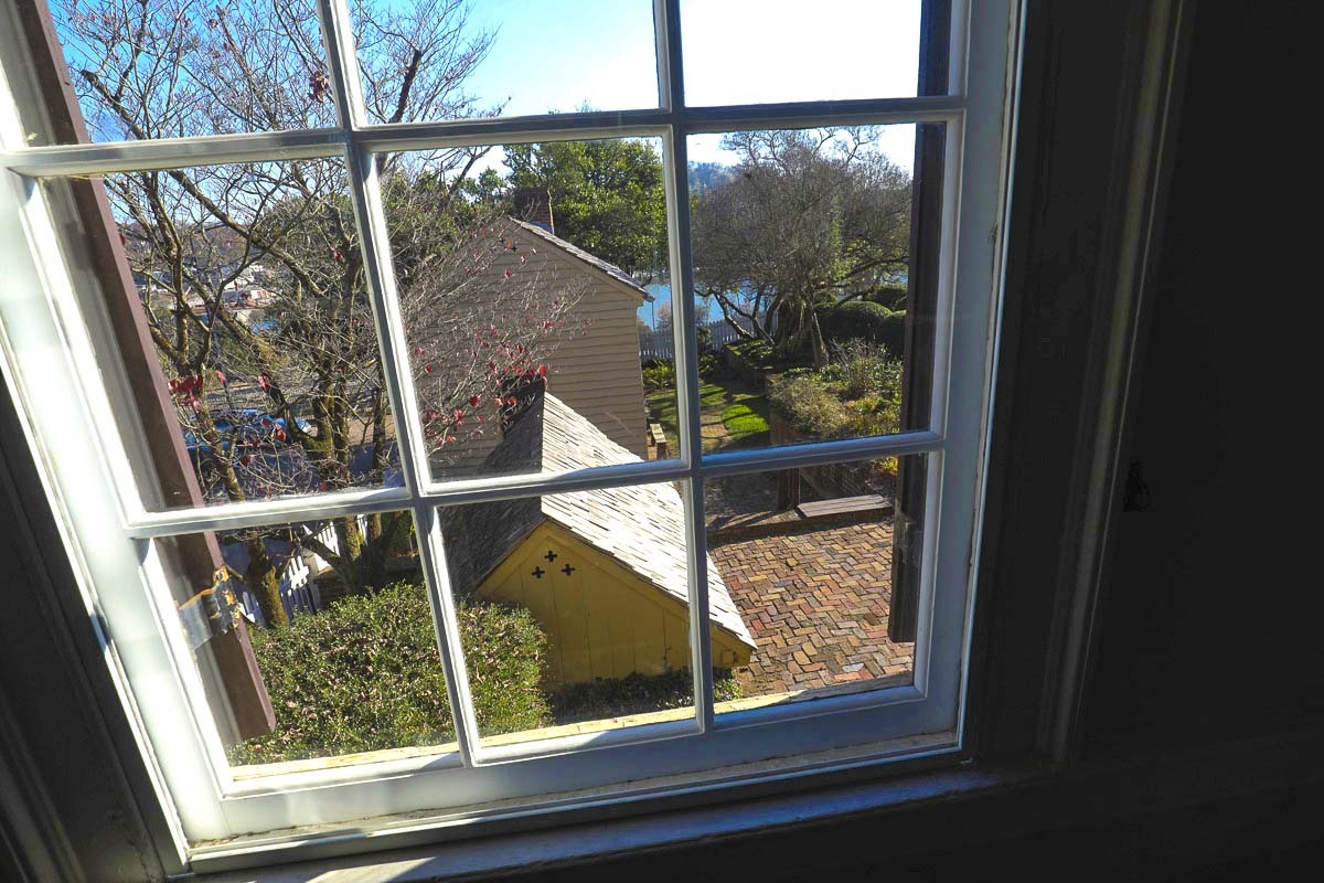 A window view of the mansion grounds