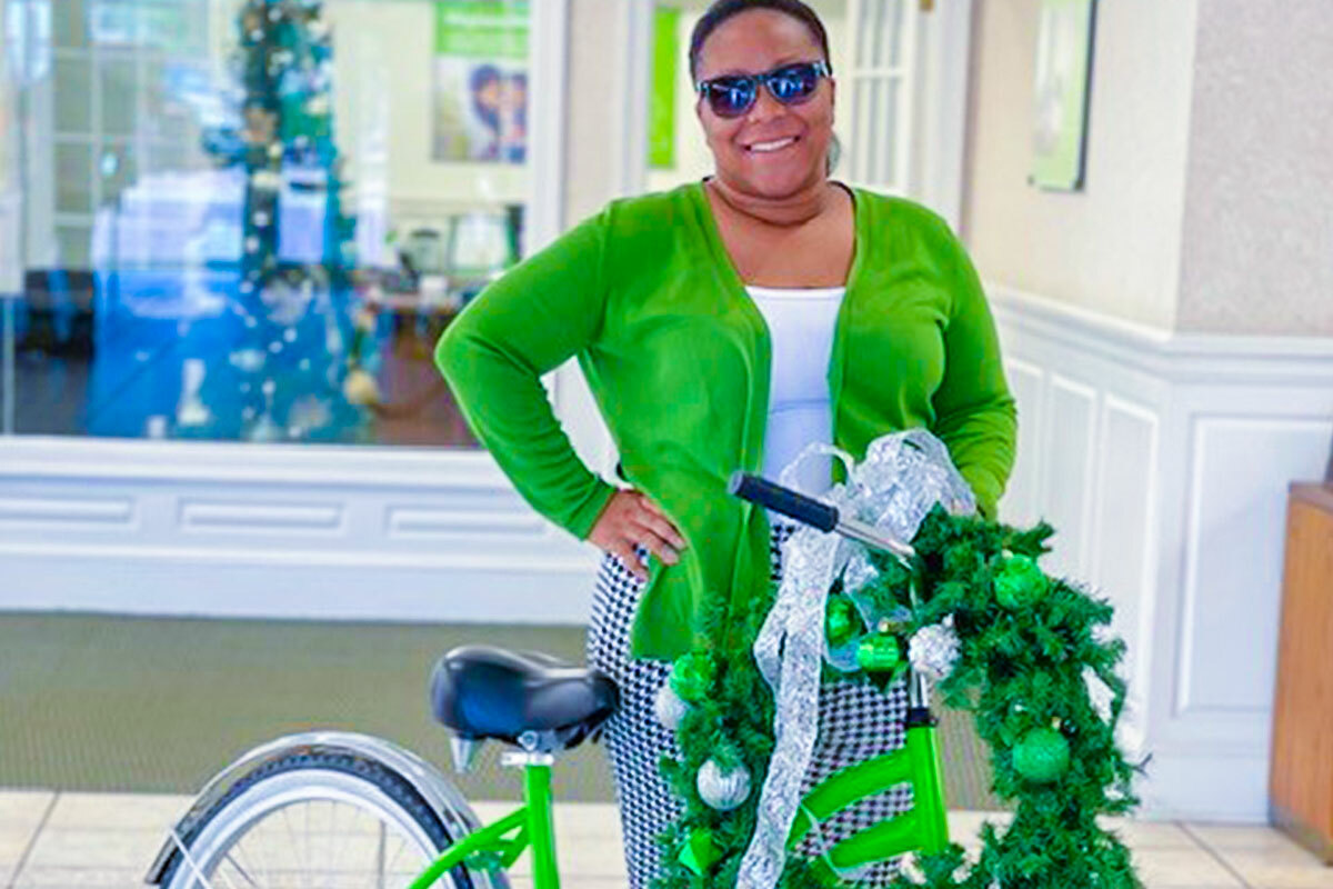 Big bike decorated for holidays next to the person wearing green outfit