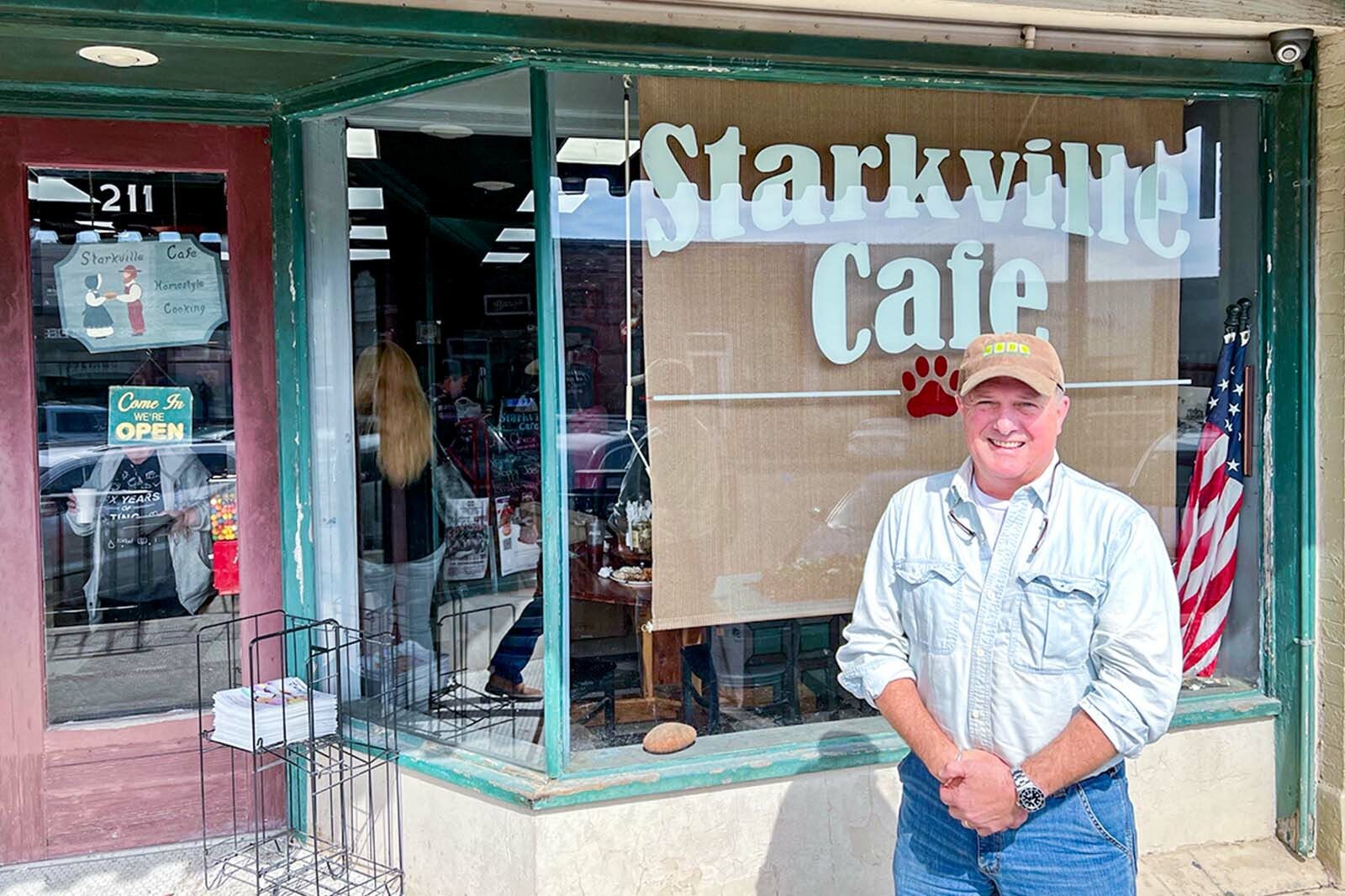 man standing in front of Starkville Cafe