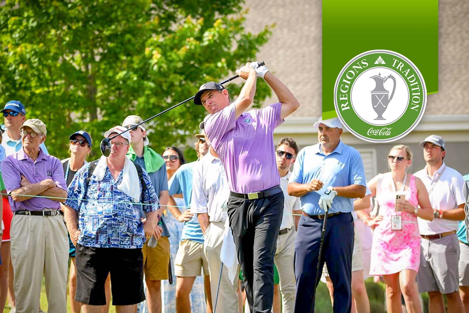 Steve Alker taking a swing with a crowd of onlookers...