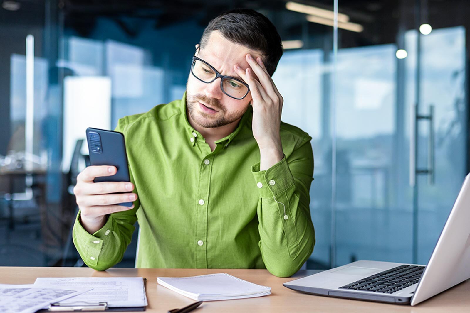 Worried young male businessman upset about potential job scams.