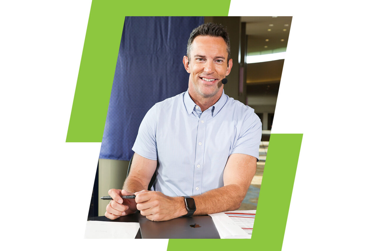 Peter Burns at a desk with a headset on.