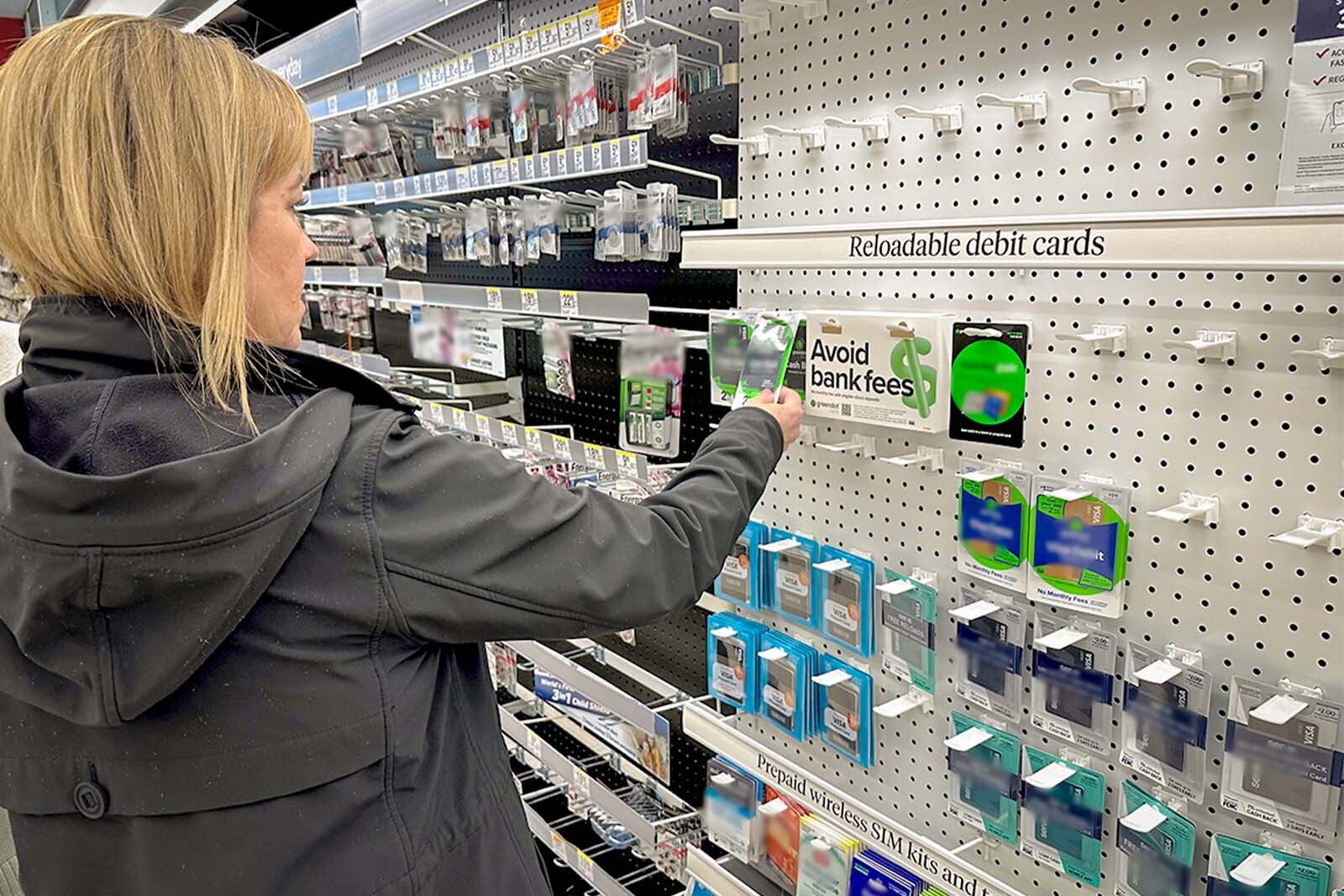 Woman shopping for prepaid cards at a store.