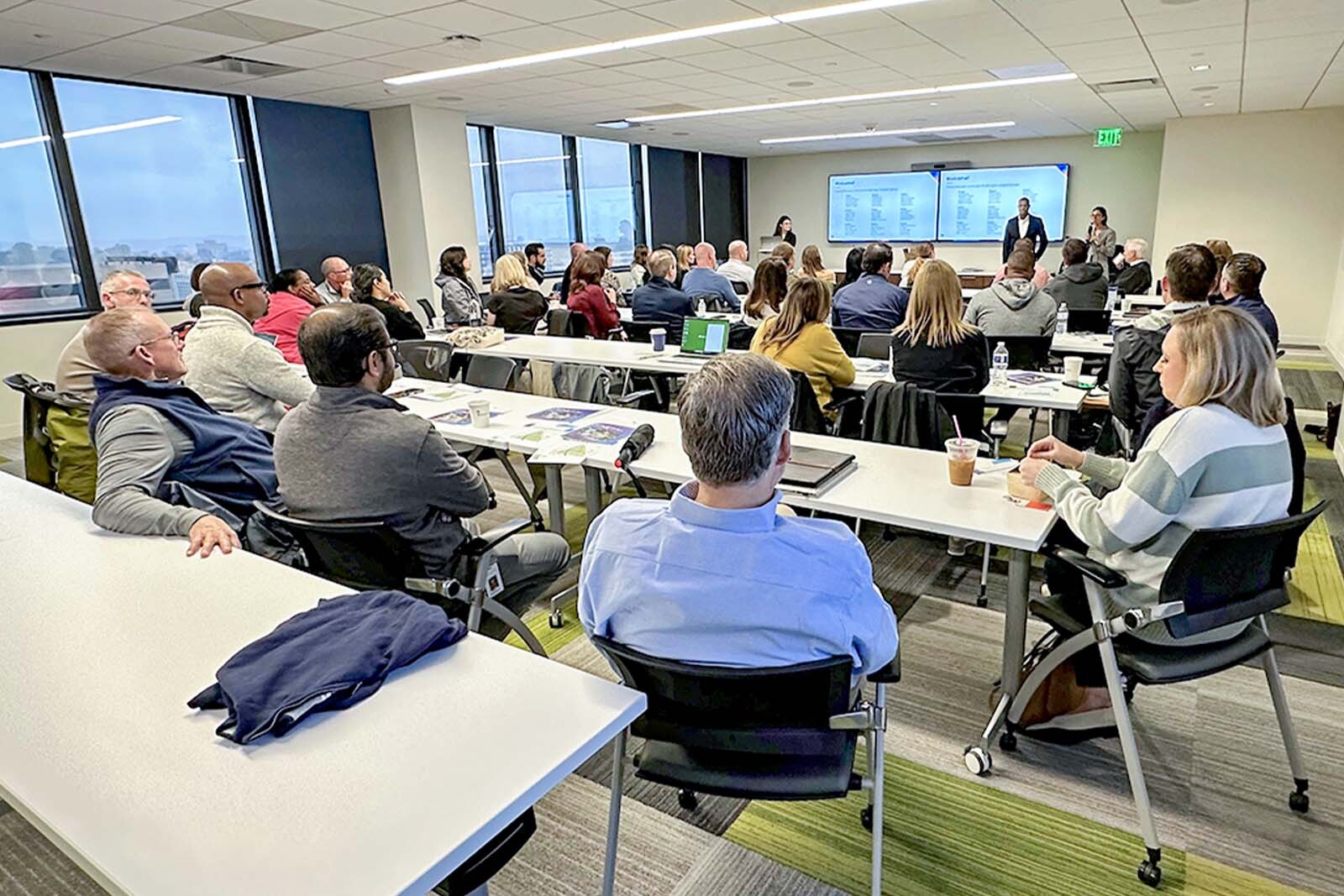 Wide shot of classroom with all attendees. 