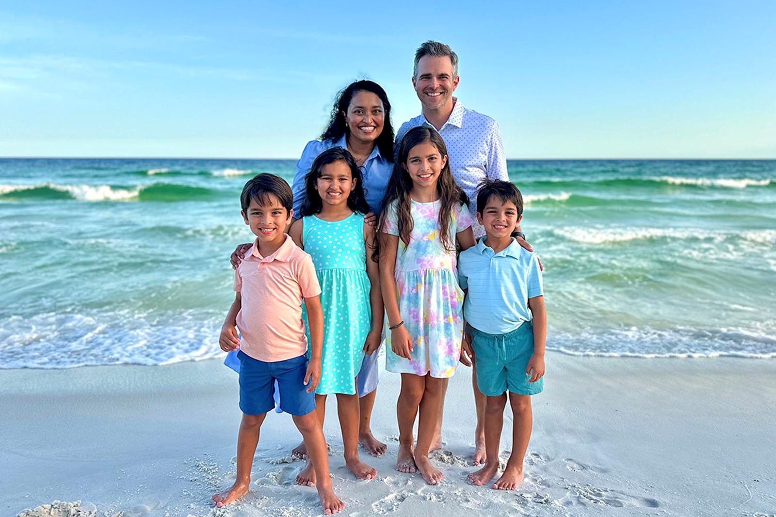 Joanna Clayton with her husband and four kids on the beach.