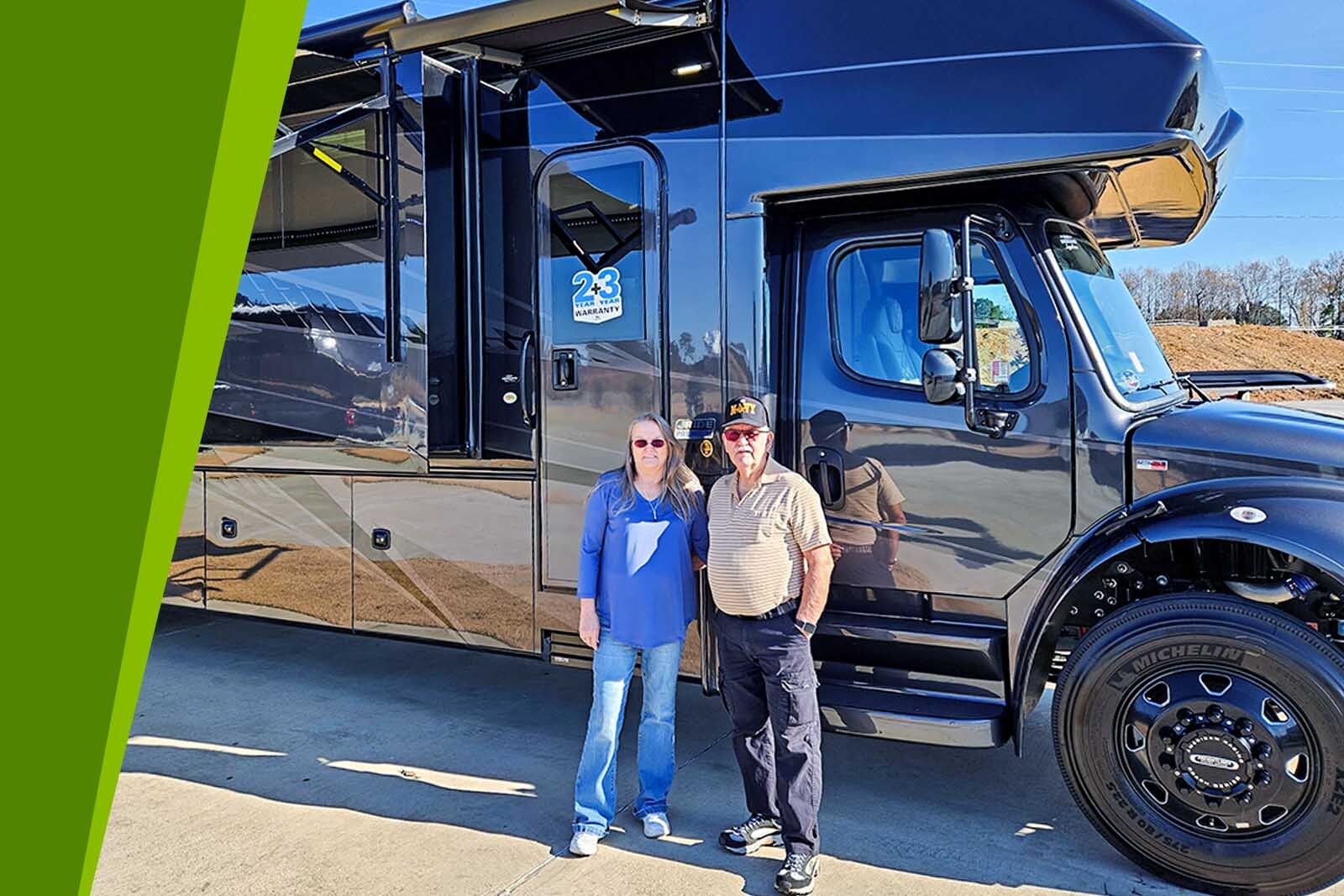 Linda and Richard Steadman standing in front of their camper.