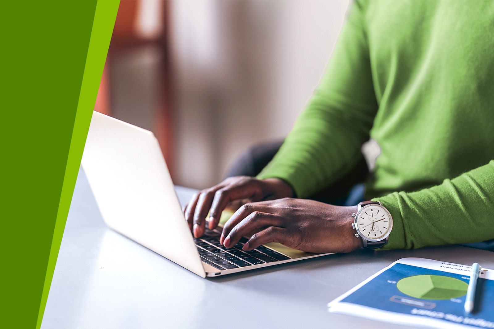 Person using laptop with chart paper work and pen on...