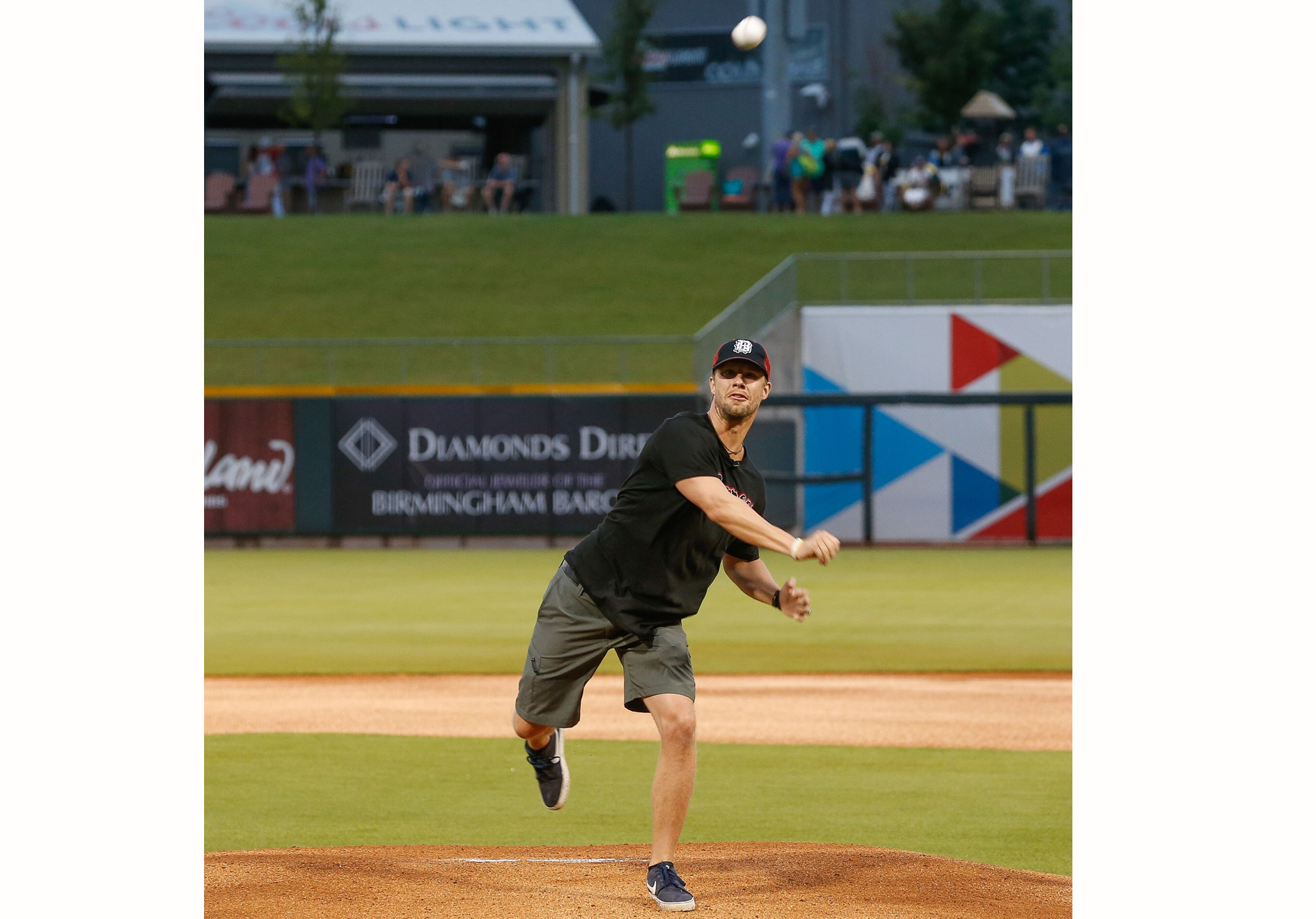 a man throwing a ball at a baseball field