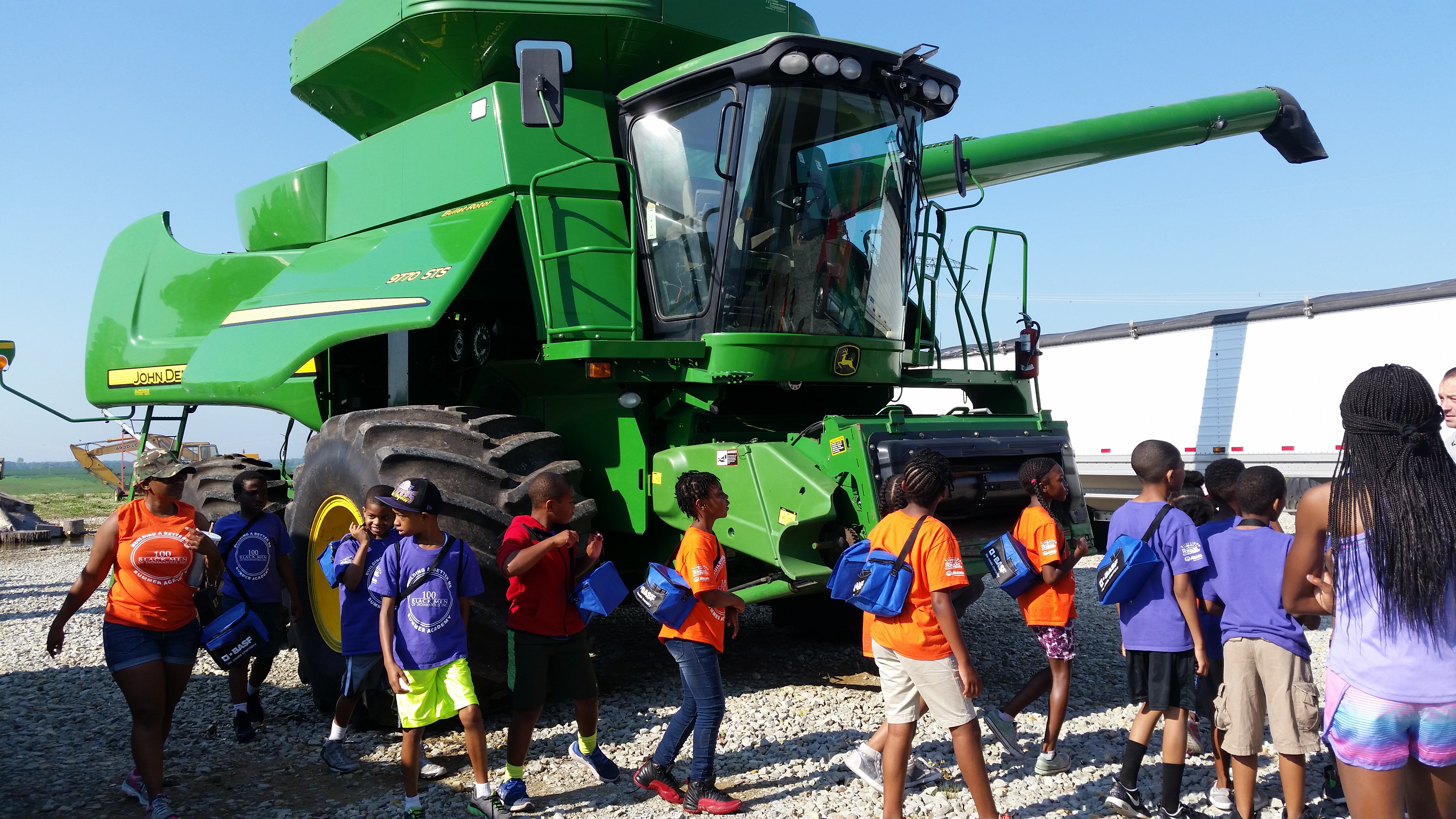 kids examining equipment during farm tour