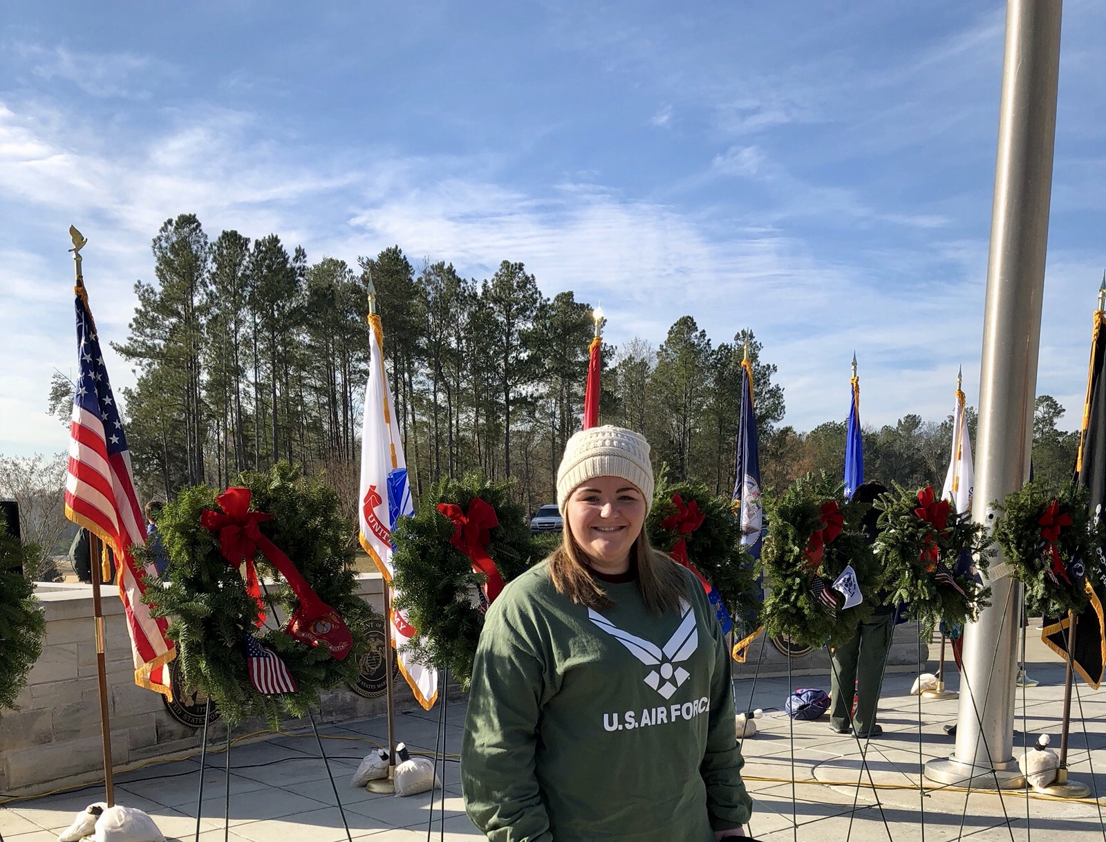 woman standing in front of memorial wreaths