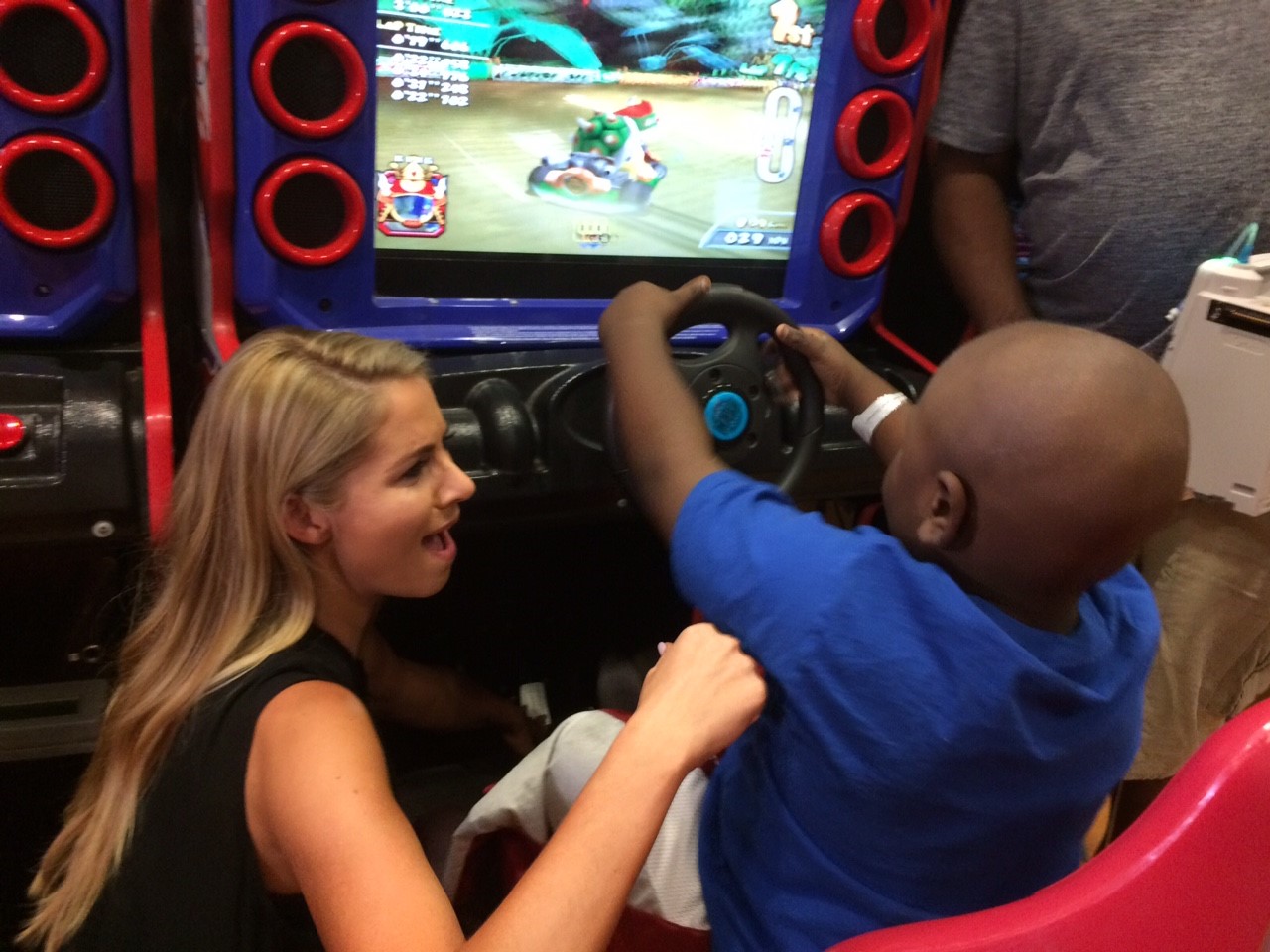 Laura Rutledge playfully reacts to a competitive video game in the Magic Room at Children's.
