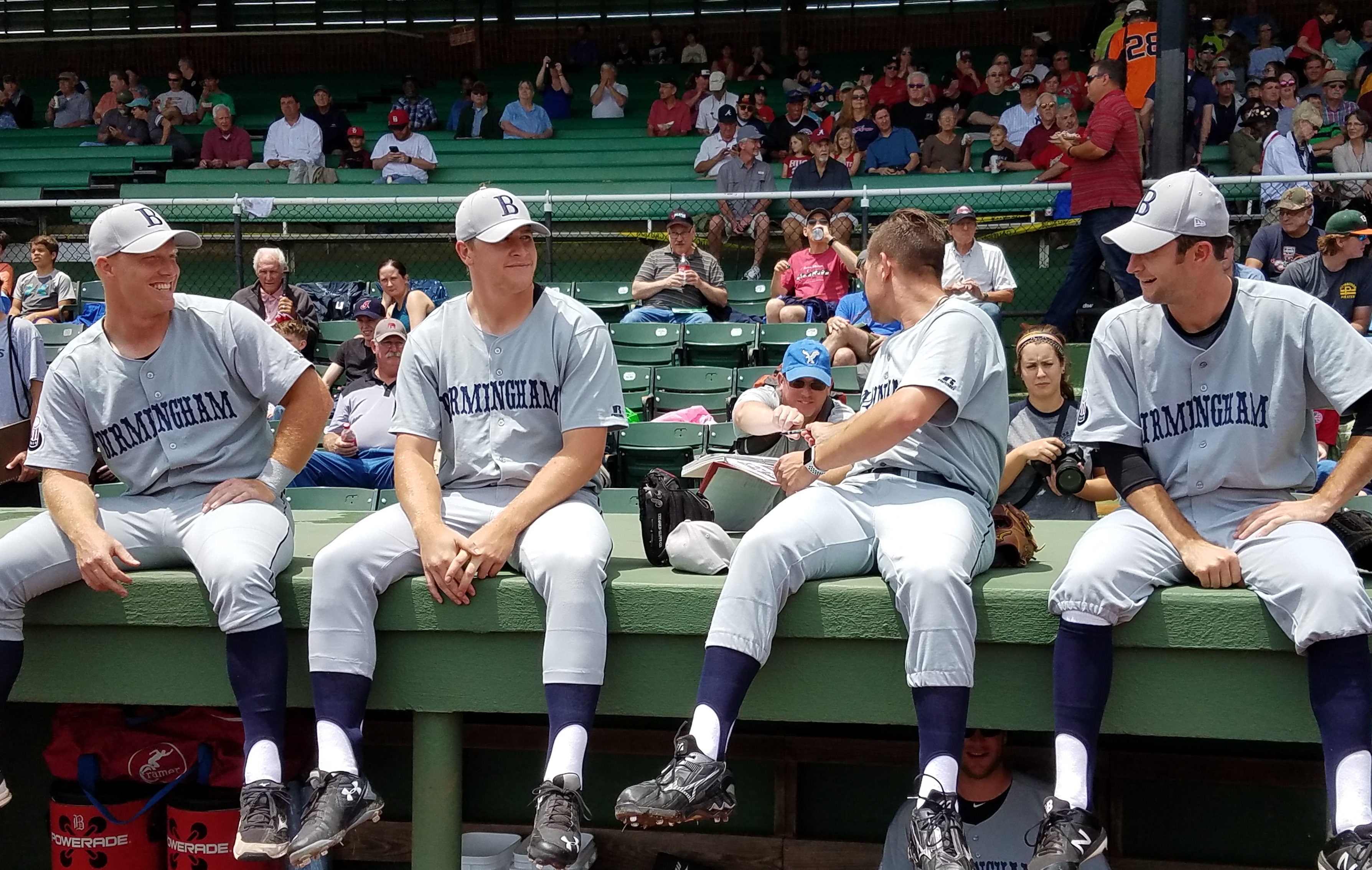 Birmingham Barons baseball players sitting on dugout
