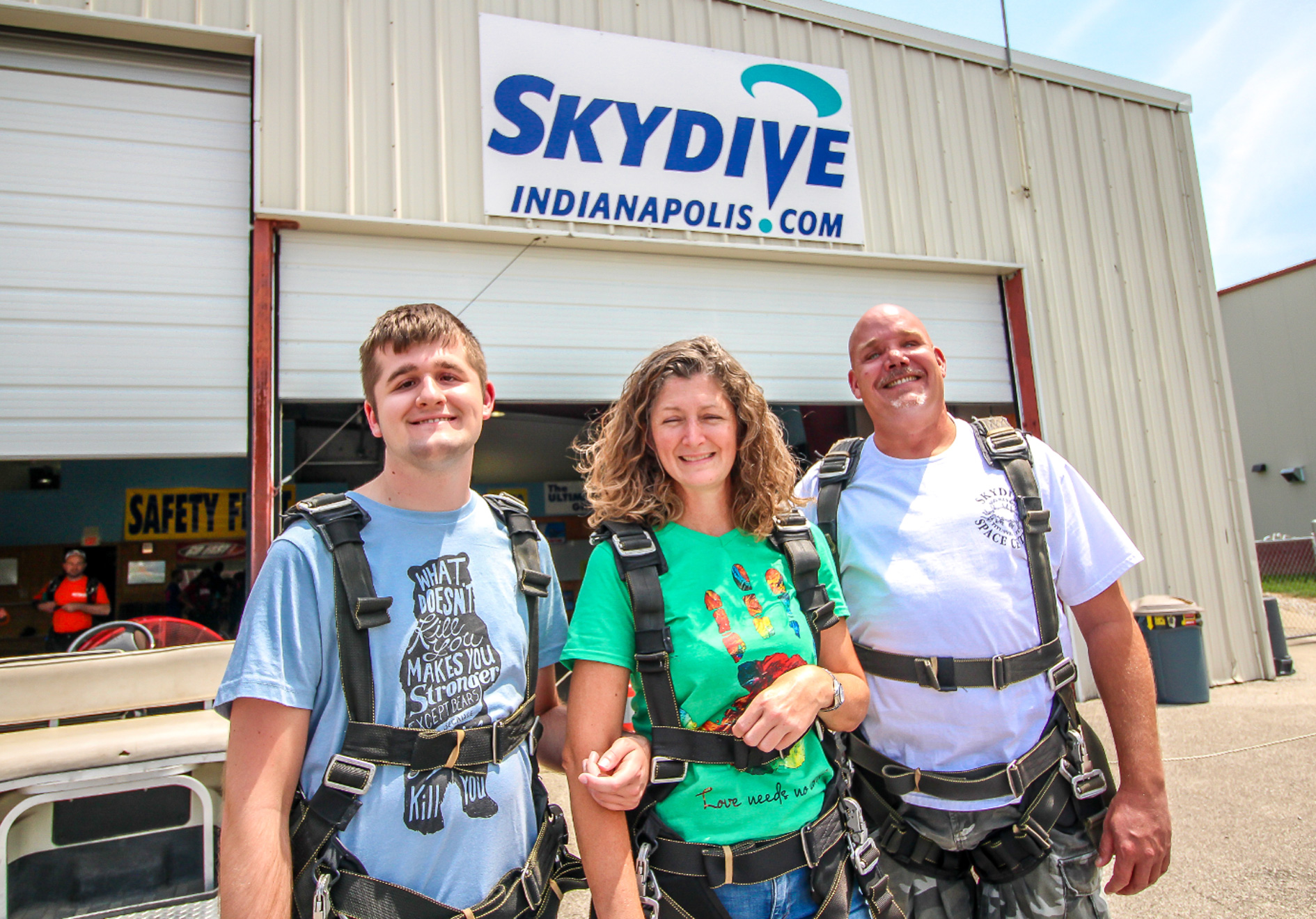 three people in skydiving gear